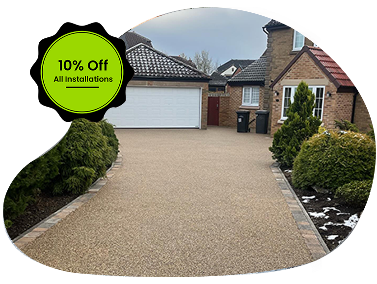 Beige resin-bound driveway with stone edging outside a Newcastle home, overlaid by a green badge reading ‘10% Off All Installations